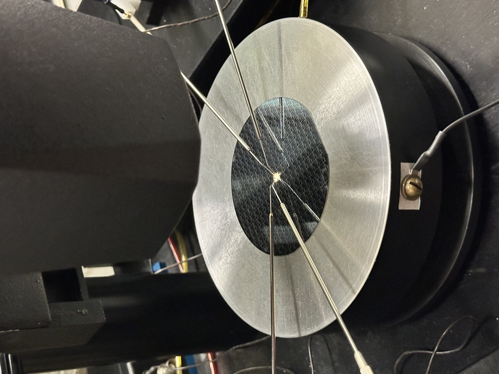 Probe station testing a fabricated silicon wafer